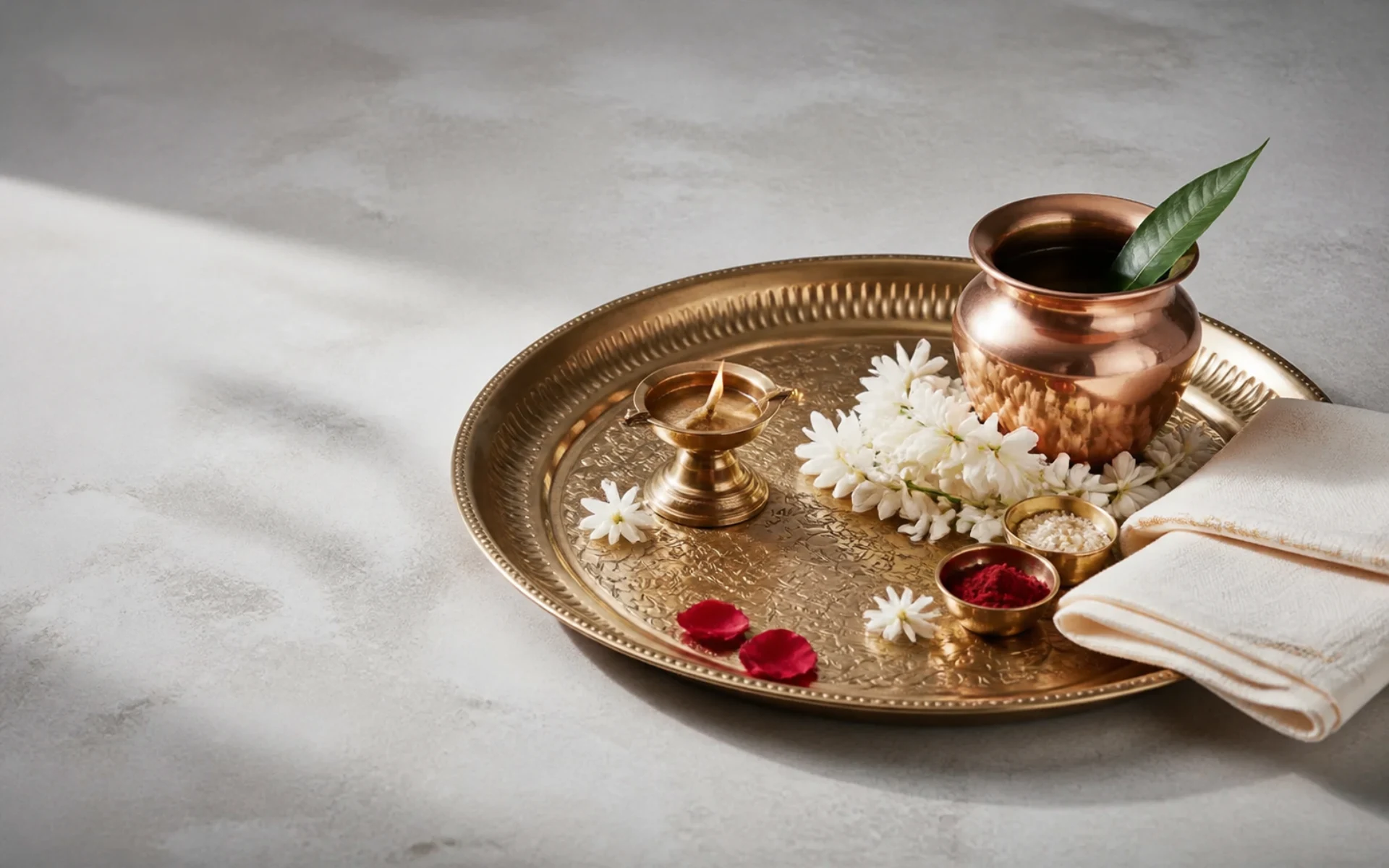 A prepared pooja thali with traditional offering objects
